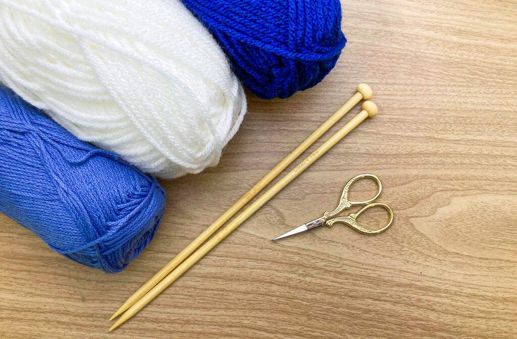 Three yanks of yarn, a couple of knitting needles and a scissor